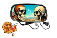 rear view mirror with skeleton looking in the corner of the mirror smoking. joint, with a 60s western landscape and aest tattoo design idea