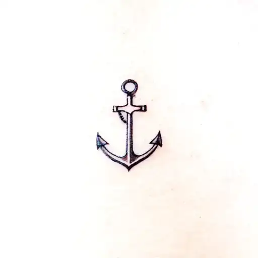 A minimalist anchor tattoo with a small Jesus cross incorporated, symbolizing your faith and dedication to your Navy service tattoo design idea