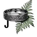 A Welsh wedding ring tattoo with the Celtic band along the top and then a New Zealand fern and the letter J on the under tattoo design idea