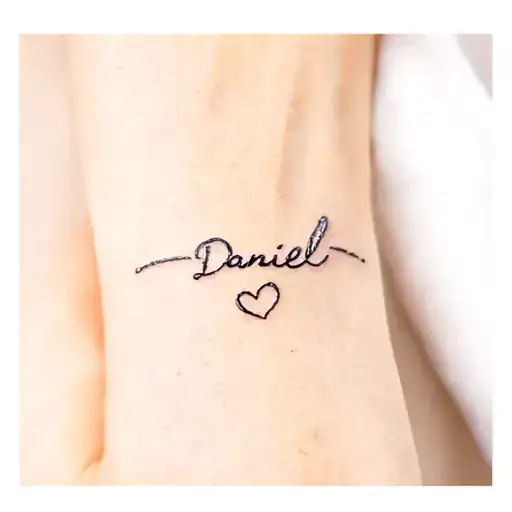 Name Daniel in Japanese on the side of the wrist with a small heart. tattoo design idea