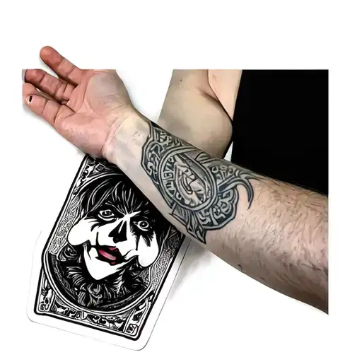 Full sleeve tattoo covering the forearm, black and grey style. On the top side of the forearm: a playing card "Joker" fe tattoo design idea