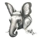 elephant n butterfly wing for ears surrounded tattoo design idea