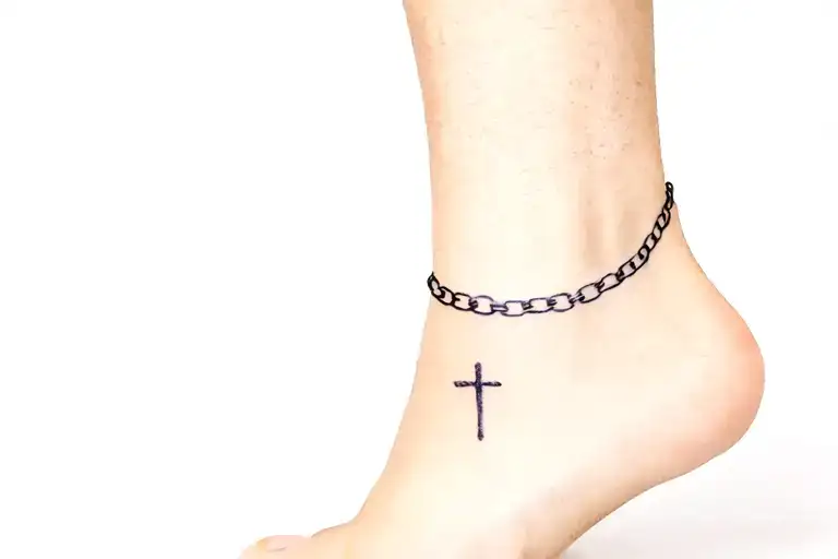 chain around right ankle with cros in it tattoo design idea